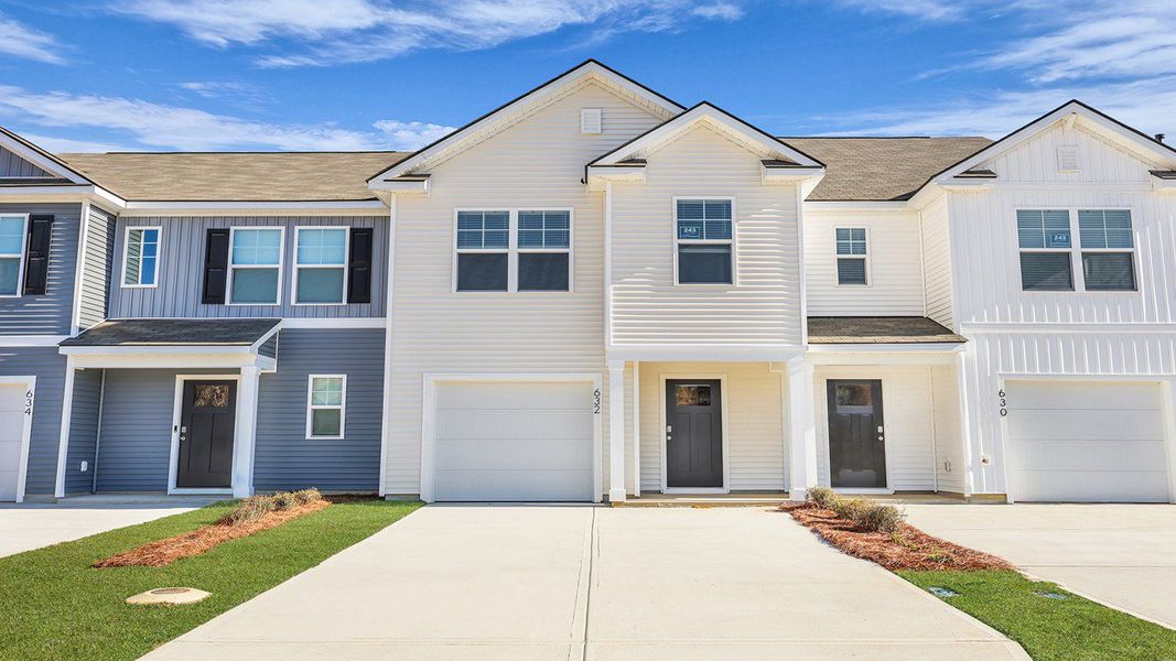 Front exterior of a new home in Pine Hills Townhomes at Cane Bay, Summerville, SC, highlighting curb appeal (Image 22). Front exterior of a new home in Pine Hills Townhomes at Cane Bay, Summerville, SC, highlighting curb appeal (Image 22).