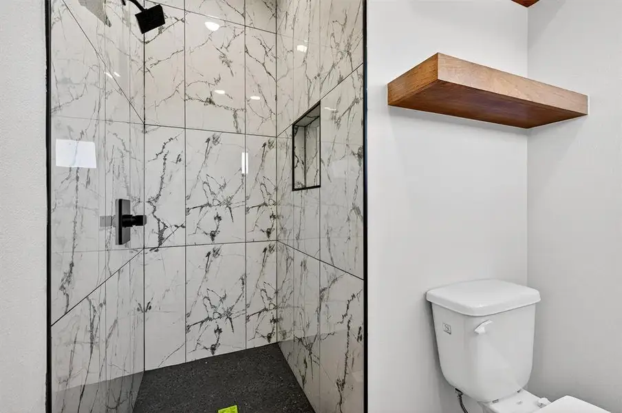 Bathroom with a marble finish shower