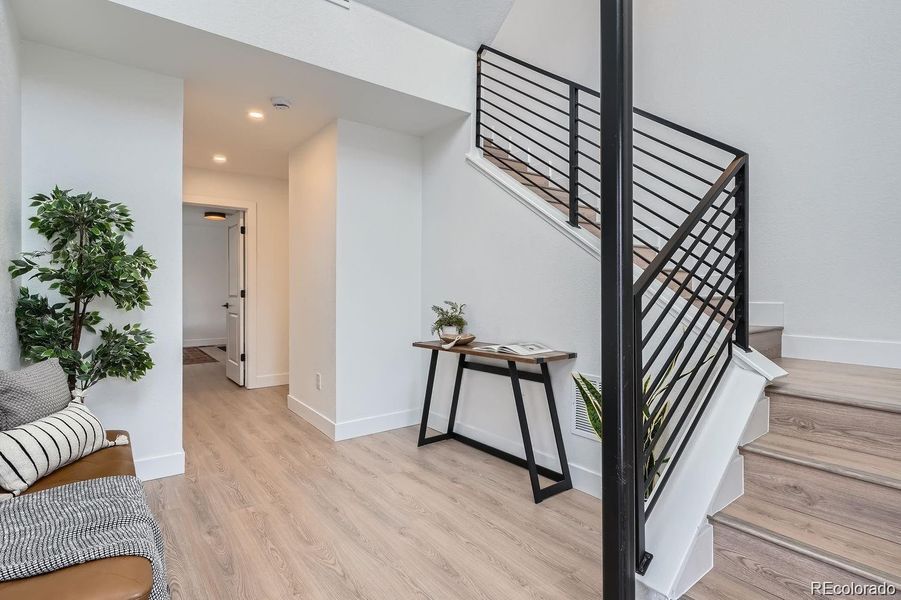 Multilevel atrium entryway flooded with natural light.