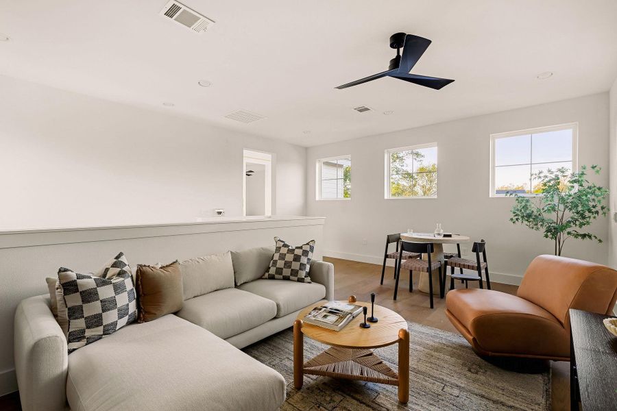 Living room with ceiling fan, wood finished floors, and recessed lighting Living room with ceiling fan, wood finished floors, and recessed lighting
