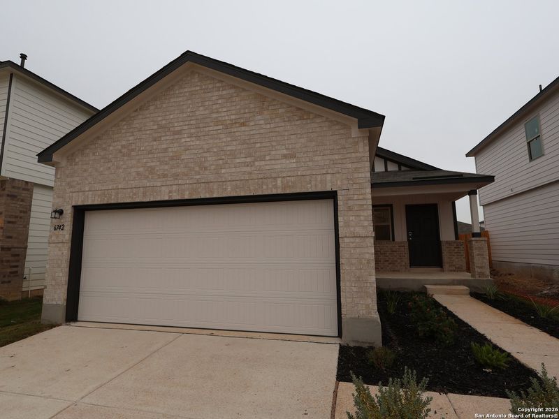 Front exterior of a new home in Winding Brook, San Antonio, TX, highlighting curb appeal (Image 18).