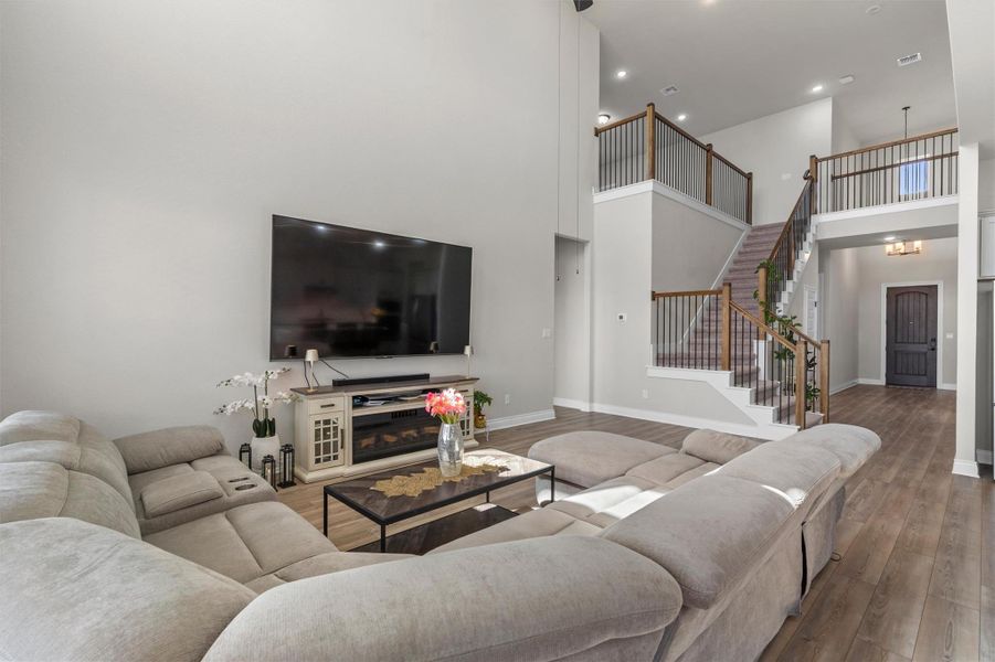 Soaring ceilings and a grand staircase frame this light-filled main gathering area.
