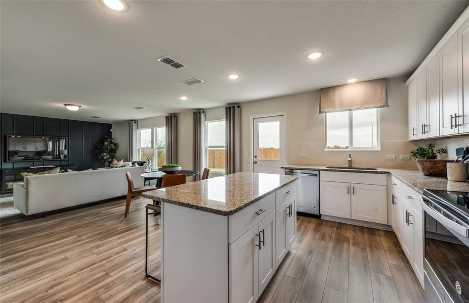 *Model Representation - Large island overlooking gathering room and dining areas