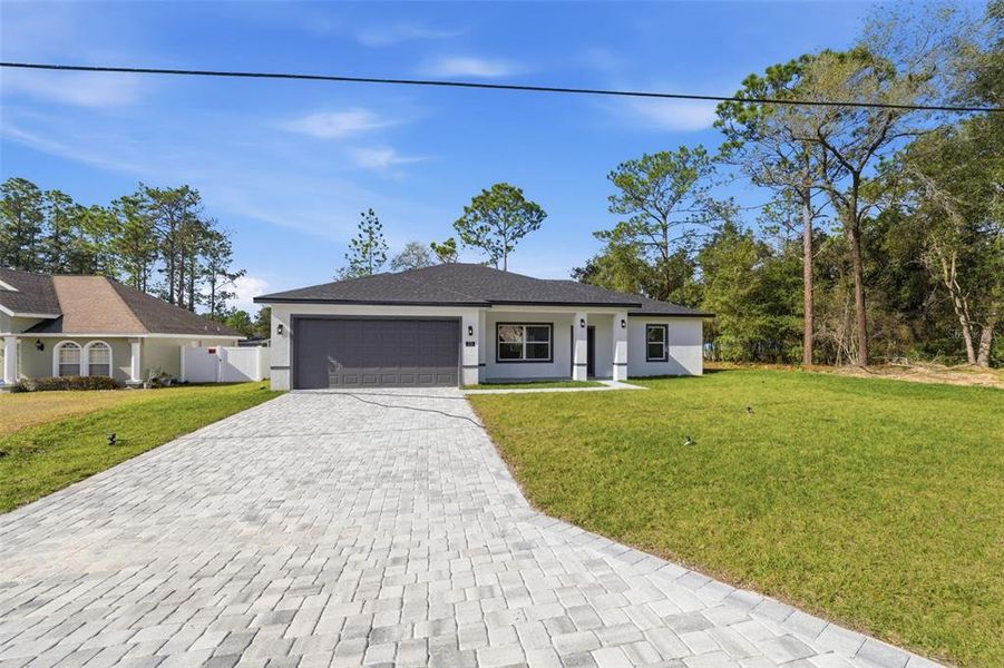 Front exterior of a new home in , Citrus Springs, FL, highlighting curb appeal (Image 21). Front exterior of a new home in , Citrus Springs, FL, highlighting curb appeal (Image 21).