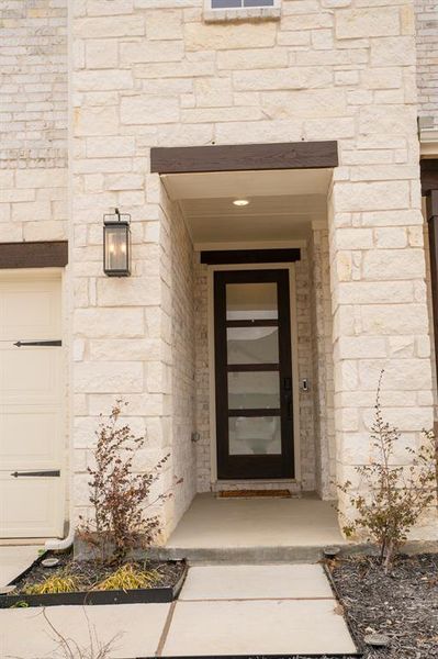 Doorway to property featuring stone siding