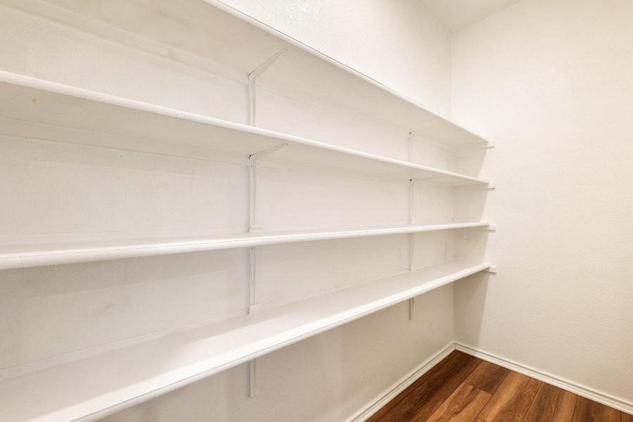 Ample storage space with extensive shelving in this functional pantry. Ample storage space with extensive shelving in this functional pantry.