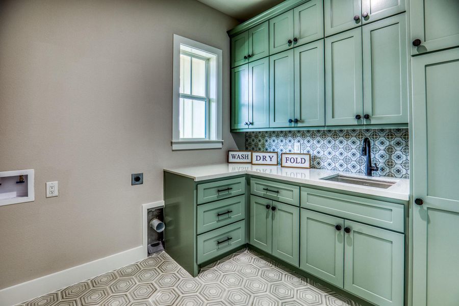 Utility room located near the primary suite Utility room located near the primary suite