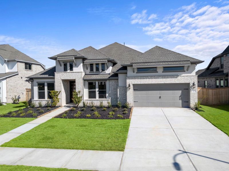 Front exterior of a new home in Valencia 70', Manvel, TX, highlighting curb appeal (Image 23).