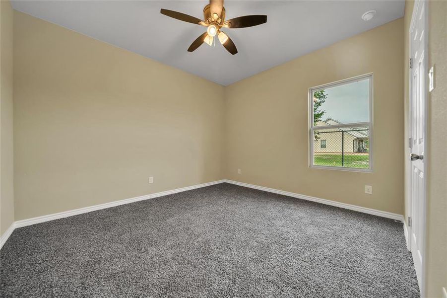 Unfurnished room featuring carpet flooring and ceiling fan