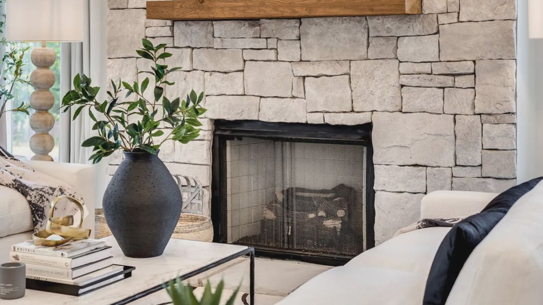 Stone designed fireplace in living area.