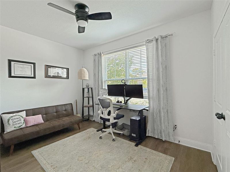Home office featuring wood finished floors, a textured ceiling, and ceiling fan Home office featuring wood finished floors, a textured ceiling, and ceiling fan