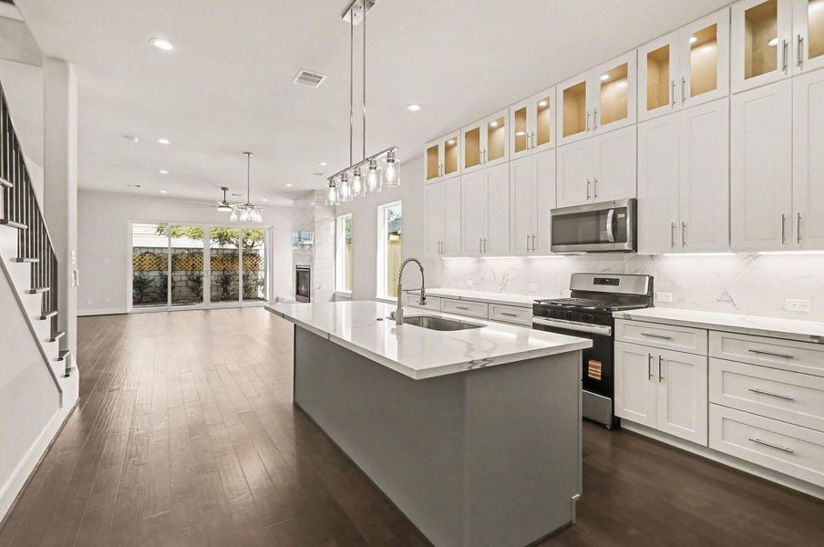 Open kitchen and dining area with modern lighting and an airy, contemporary feel