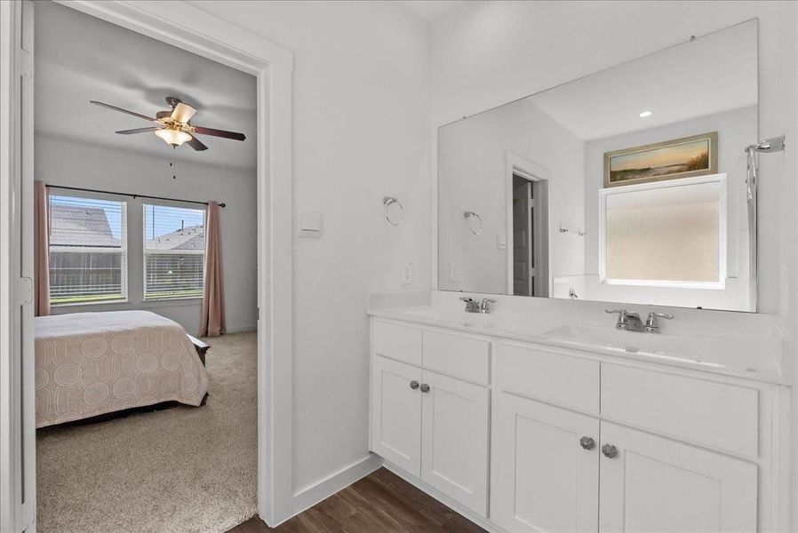 The private primary en-suite bath offers dual vanities, walk-in closet, soaking tub, double sinks, and a walk-in shower.