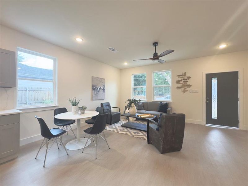 Living room with light wood-type flooring and ceiling fan