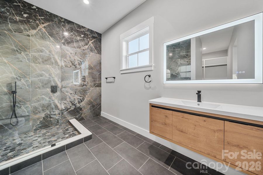Floor to ceiling tile and floating vanity