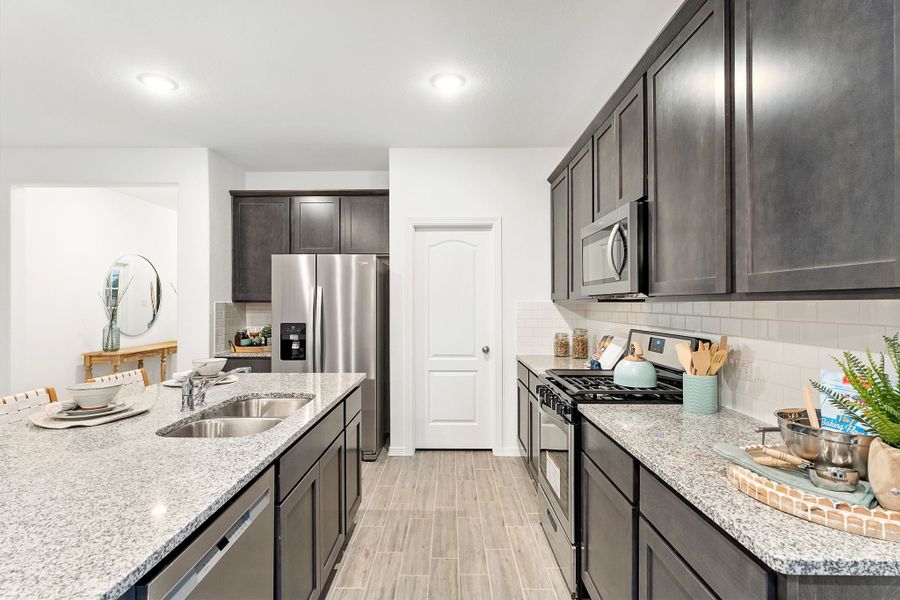 A kitchen with black cabinets.