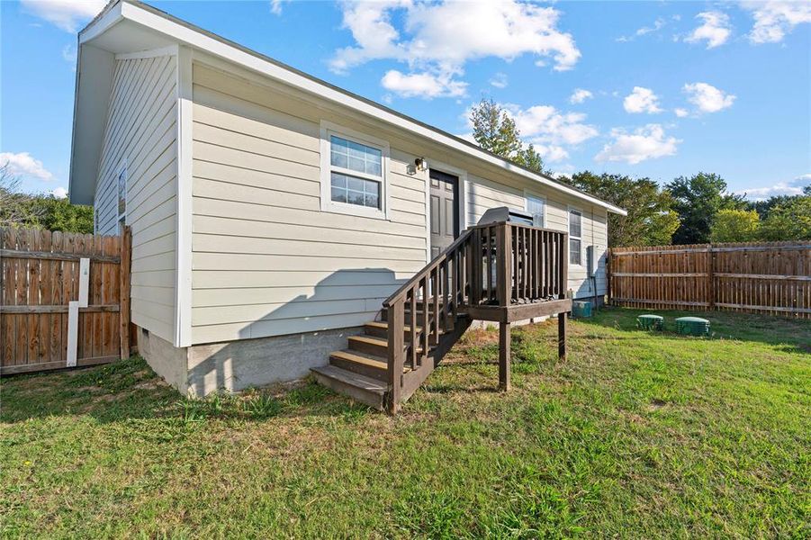 Rear view of property featuring a yard