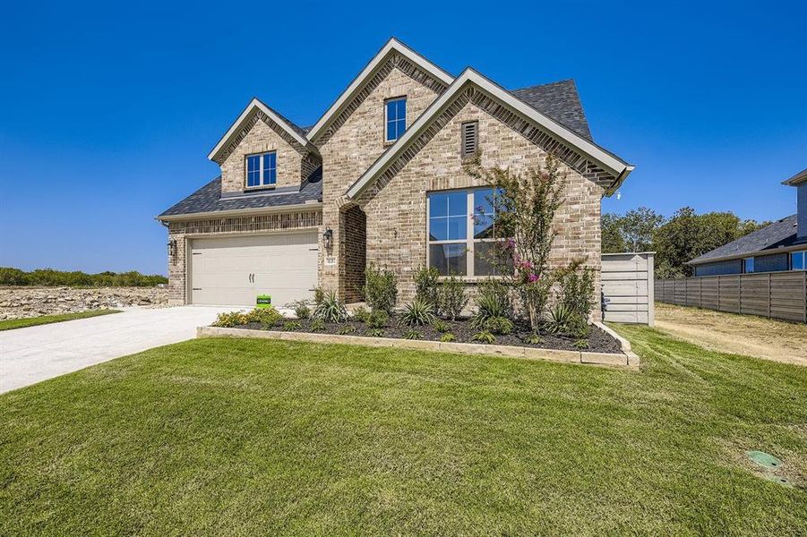 View of front of property with concrete driveway, brick siding, a shingled roof, and an attached garage View of front of property with concrete driveway, brick siding, a shingled roof, and an attached garage