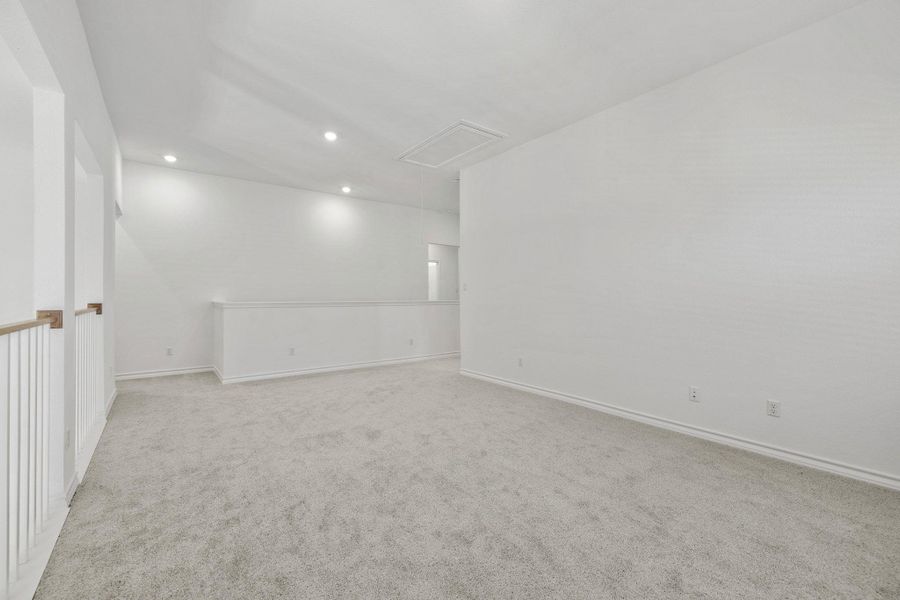 Spare room featuring recessed lighting and light carpet