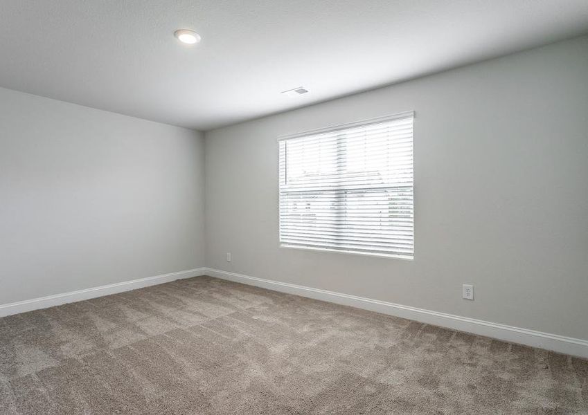 Secondary bedroom with carpet and a large window.