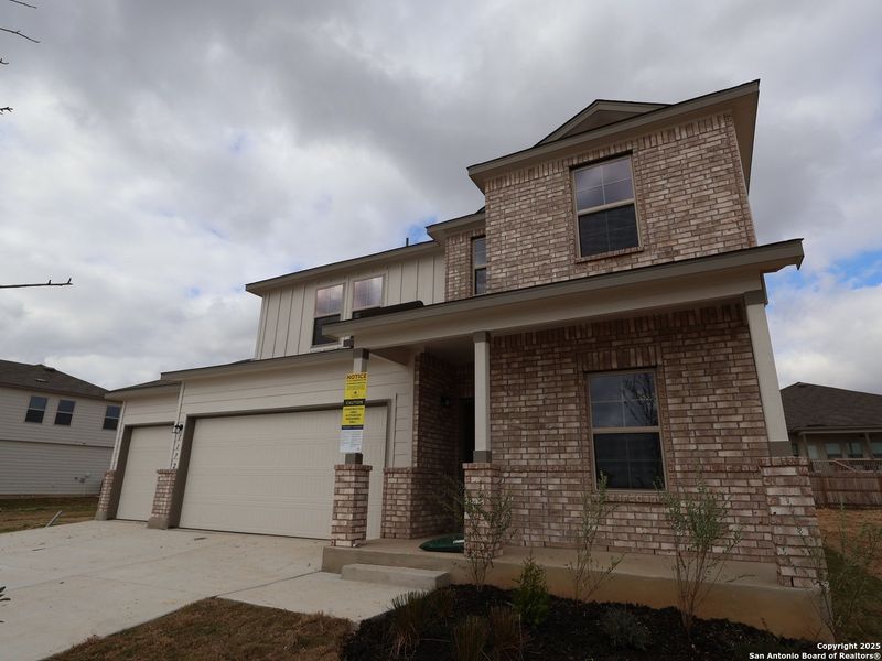 Front exterior of a new home in Greenspoint Heights, Seguin, TX, highlighting curb appeal (Image 24).