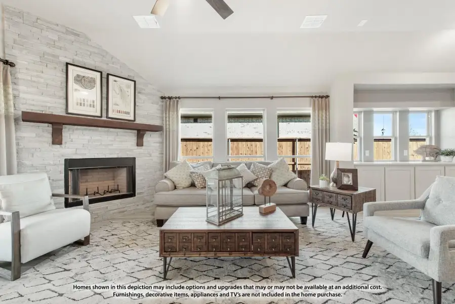 Living room with stacked stone fireplace, vaulted ceiling, neutral furniture, and large windows