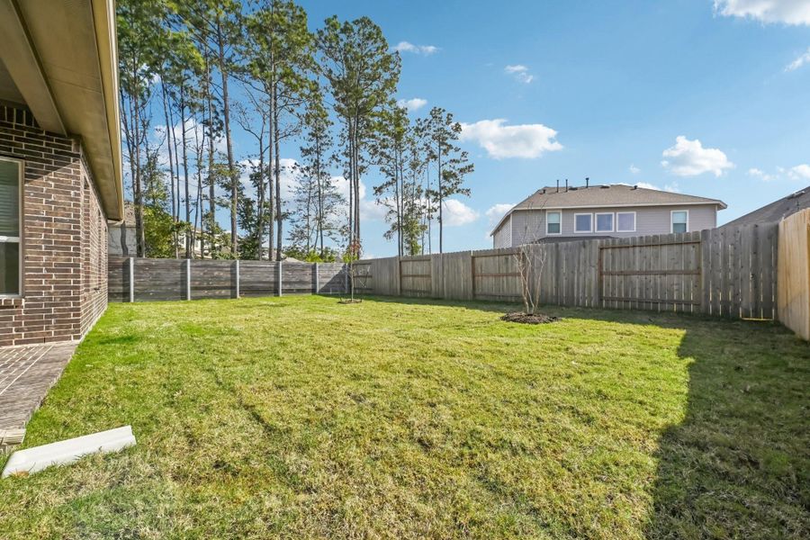 Exterior details and patio area of a home in Artavia, Conroe (Image 24).