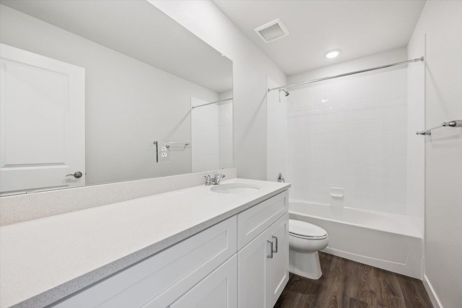 A bathroom with a tub toilet and sink. A bathroom with a tub toilet and sink.
