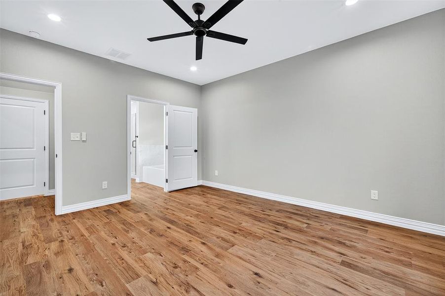 Unfurnished bedroom with light wood finished floors, recessed lighting, and ceiling fan Unfurnished bedroom with light wood finished floors, recessed lighting, and ceiling fan