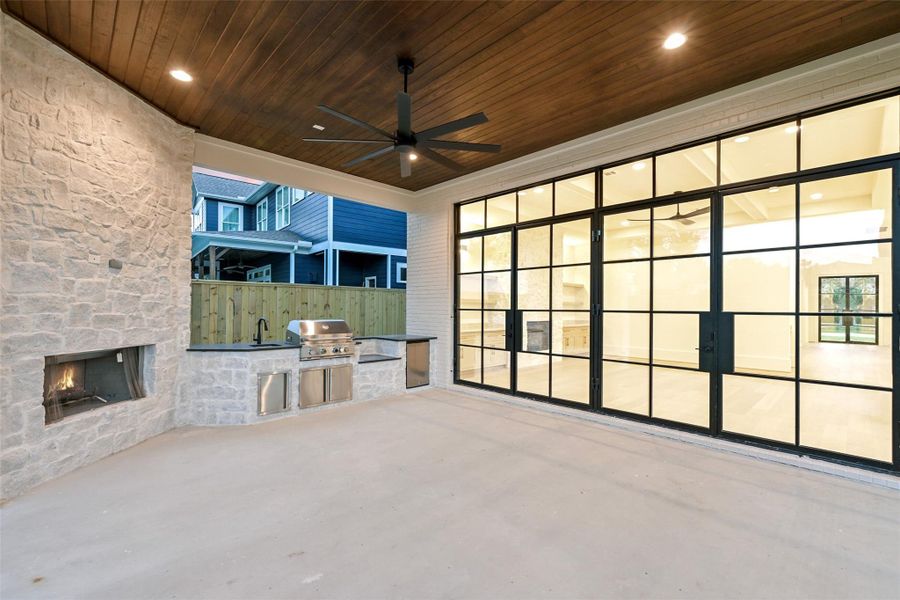 Sample of builder's previous construction. This home will have a similar outdoor veranda layout as pictured here with a fireplace and outdoor kitchen. Buyer still has time to select finishes.