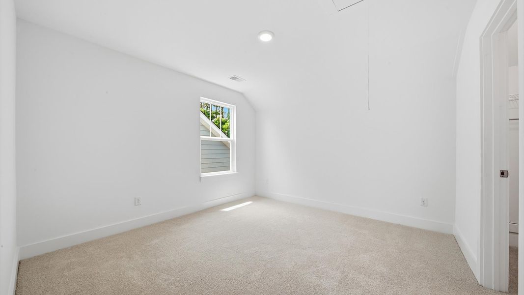 Superior comfort in a secondary bedroom with plush carpet and an oversized walk-in closet Superior comfort in a secondary bedroom with plush carpet and an oversized walk-in closet