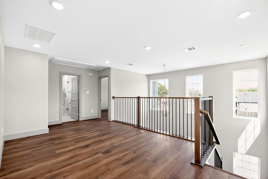 Empty room with dark wood finished floors and recessed lighting Empty room with dark wood finished floors and recessed lighting