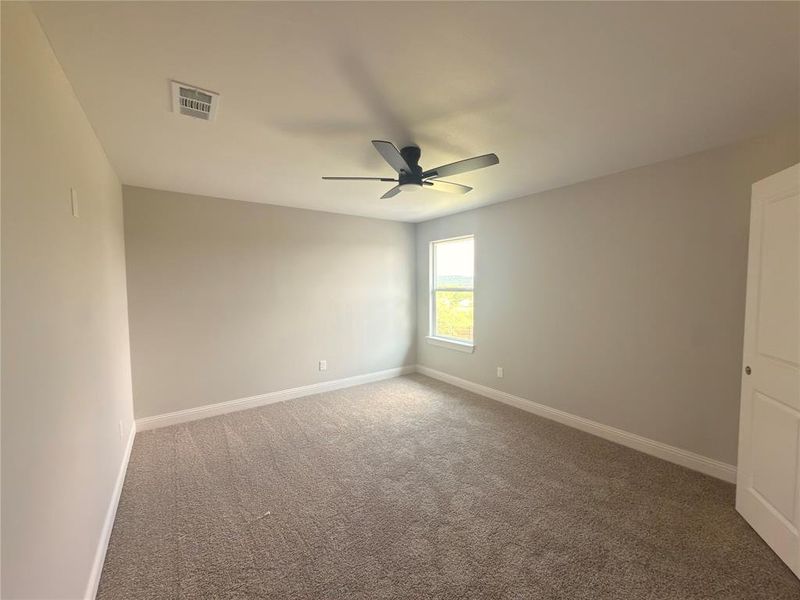 Carpeted room featuring a ceiling fan, recessed lighting, and a single window