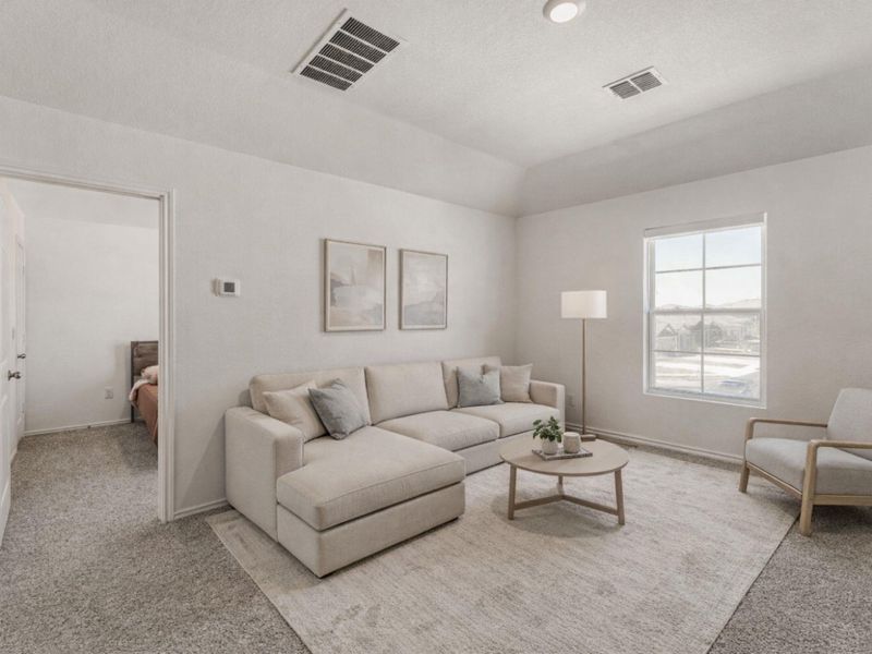 Living area featuring light carpet and vaulted ceiling
