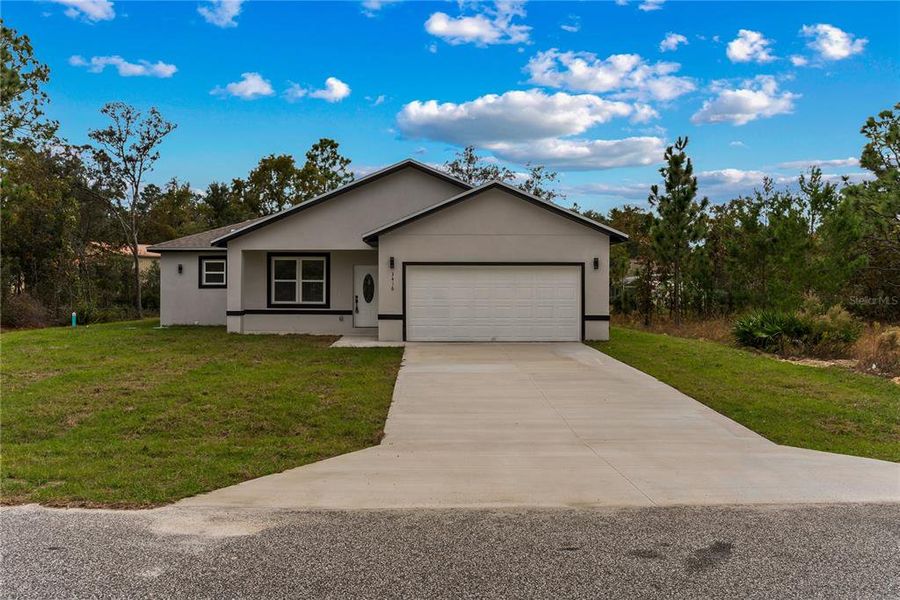 Front exterior of a new home in , Dunnellon, FL, highlighting curb appeal (Image 2).