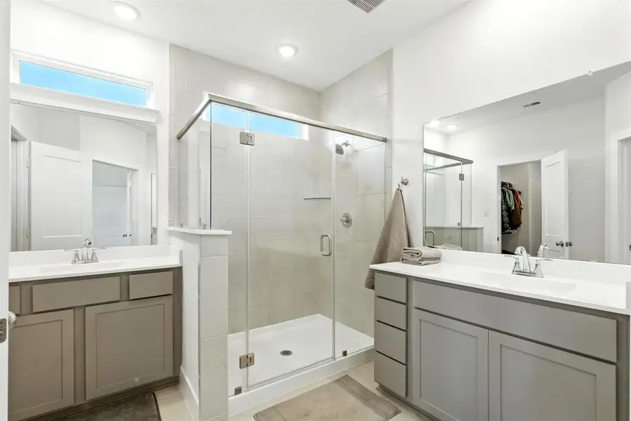 The primary bathroom also has separate vanities. The primary bathroom also has separate vanities.