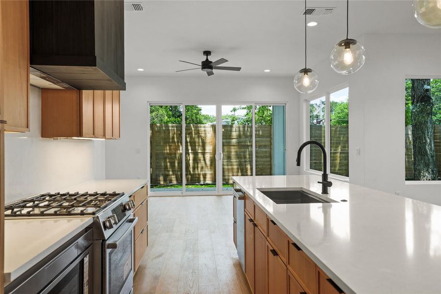 Culinary dreams come alive in this modern kitchen, boasting sleek surfaces and direct outdoor access.