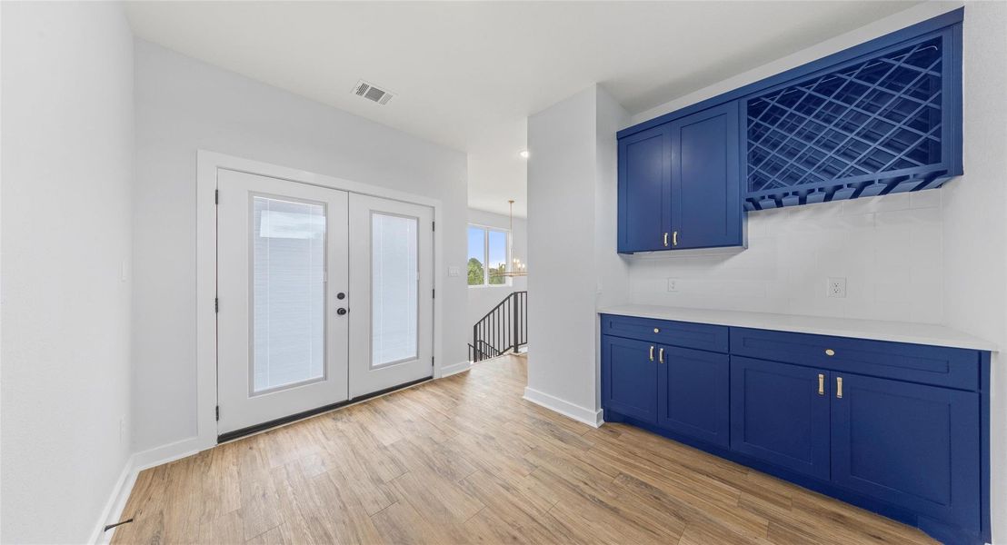 Foyer with light wood-type flooring and french doors