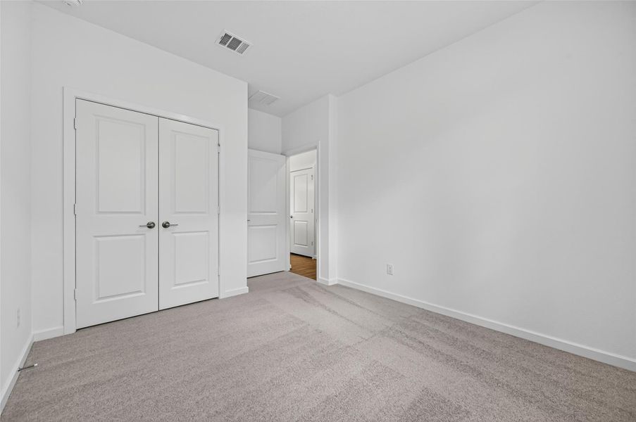 The bedroom layout includes a spacious closet with double doors and easy access to the hallway, offering both convenience and functionality.