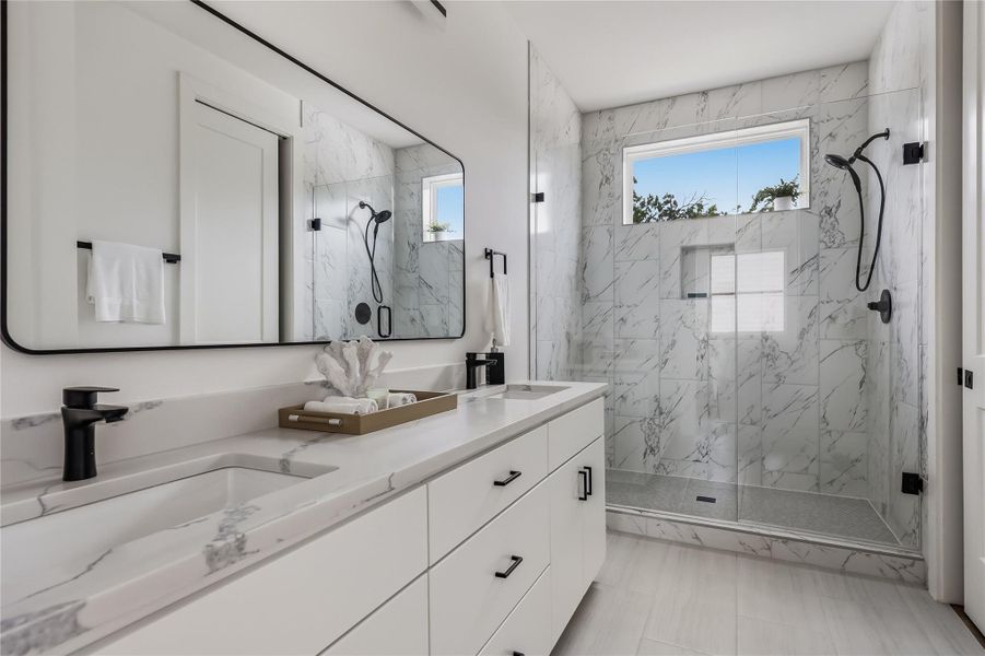 Dual vanities and a spacious glass-enclosed shower create a modern and functional bathroom oasis.