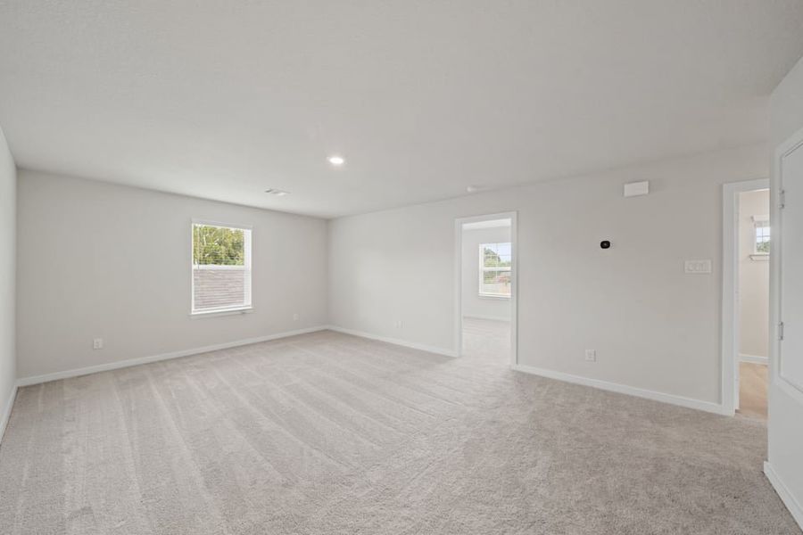 A room with a carpet and a rug. A room with a carpet and a rug.