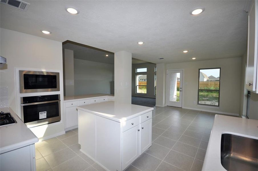 View from the utility room entrance into the kitchen, the breakfast room  the family room.