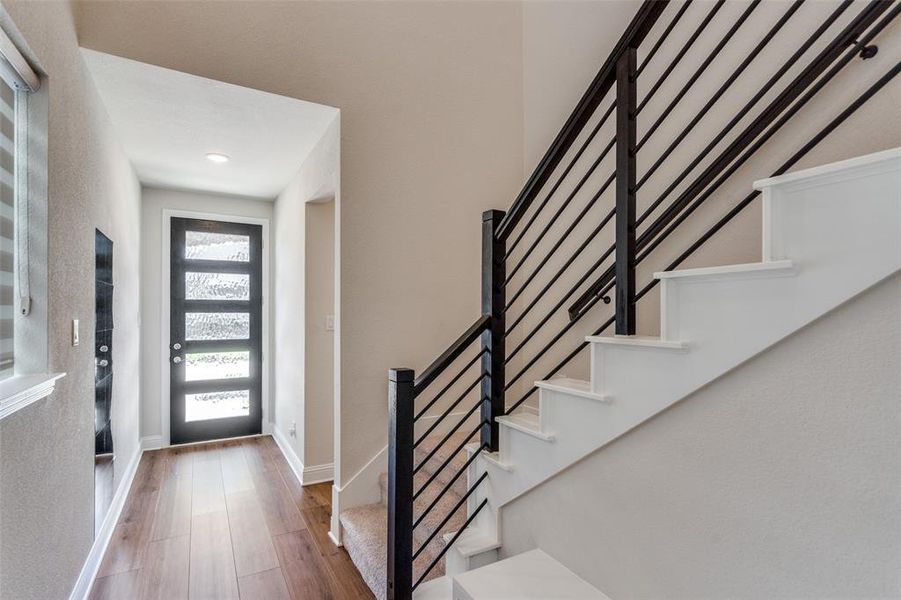 Foyer featuring wood finished floors and stairway Foyer featuring wood finished floors and stairway