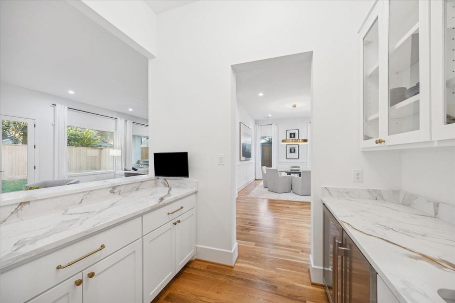 A dedicated butlers pantry adds valuable prep and storage space while keeping the main kitchen clutter free. Integrated beverage refrigeration, generous counter space, and easy access to the dining room make entertaining feel organized and effortless. A dedicated butlers pantry adds valuable prep and storage space while keeping the main kitchen clutter free. Integrated beverage refrigeration, generous counter space, and easy access to the dining room make entertaining feel organized and effortless.