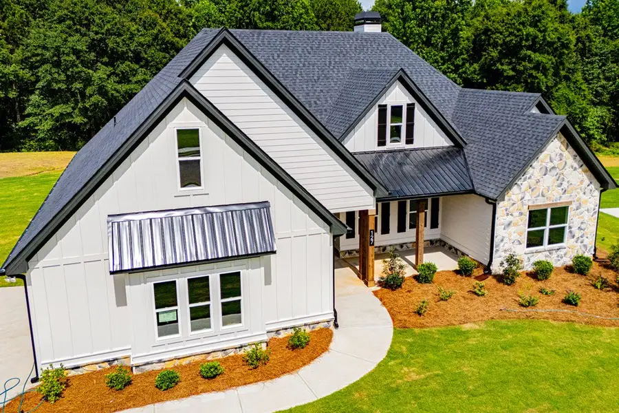 Front exterior of a new home in WOODMONT RESERVE, Roopville, GA, highlighting curb appeal (Image 37).