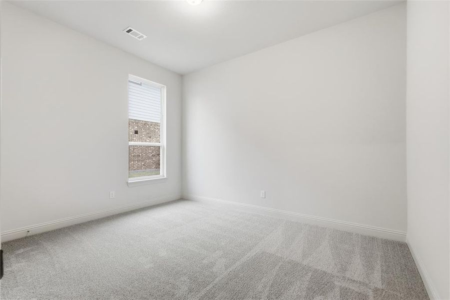 Unfurnished room with light colored carpet and baseboards
