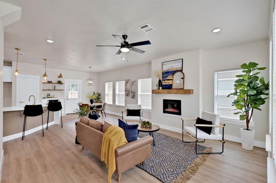 Living room featuring ceiling fan, light hardwood / wood-style floors, and sink