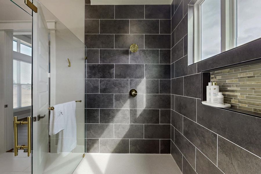Primary bath:  Totally separate shower at one end of the enclosure and the tub at the deep soaker tub at the other end. With Floor to ceiling tile. Just look at all that natural light! Why put up curtains when the property is totally private?