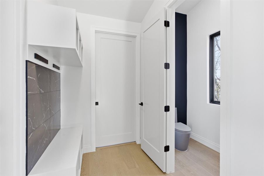 Upstairs mudroom located across from half bathroom.