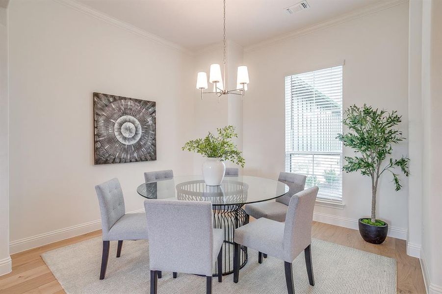 Spacious dining area with chandelier.